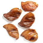 Five browned dumplings on a white background
